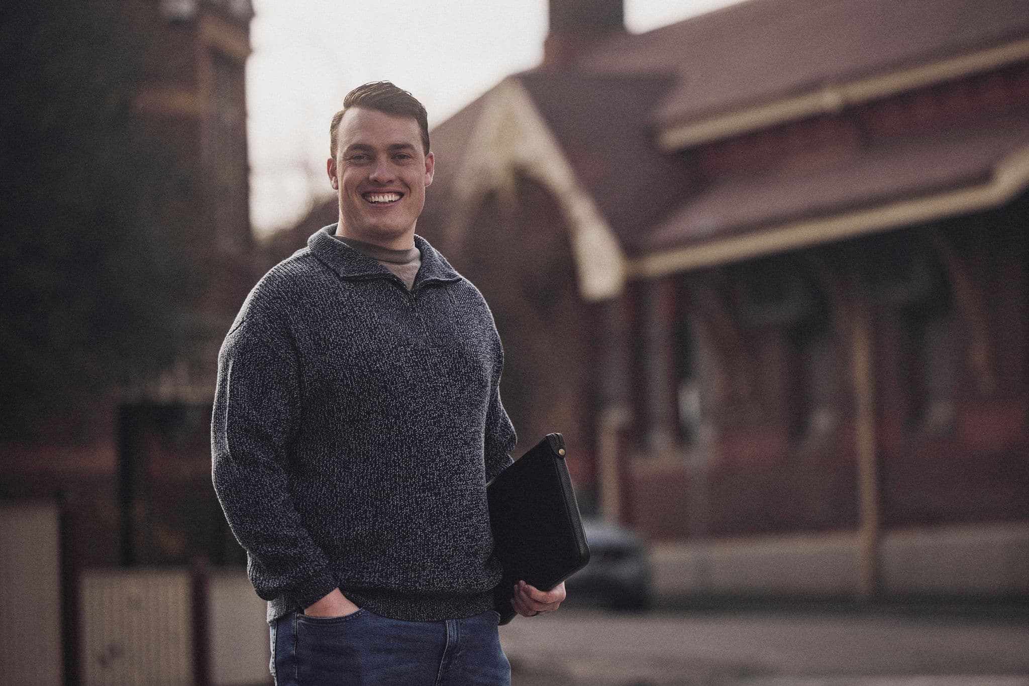 Jacob Williams outside a Melbourne house, smiling towards the camera